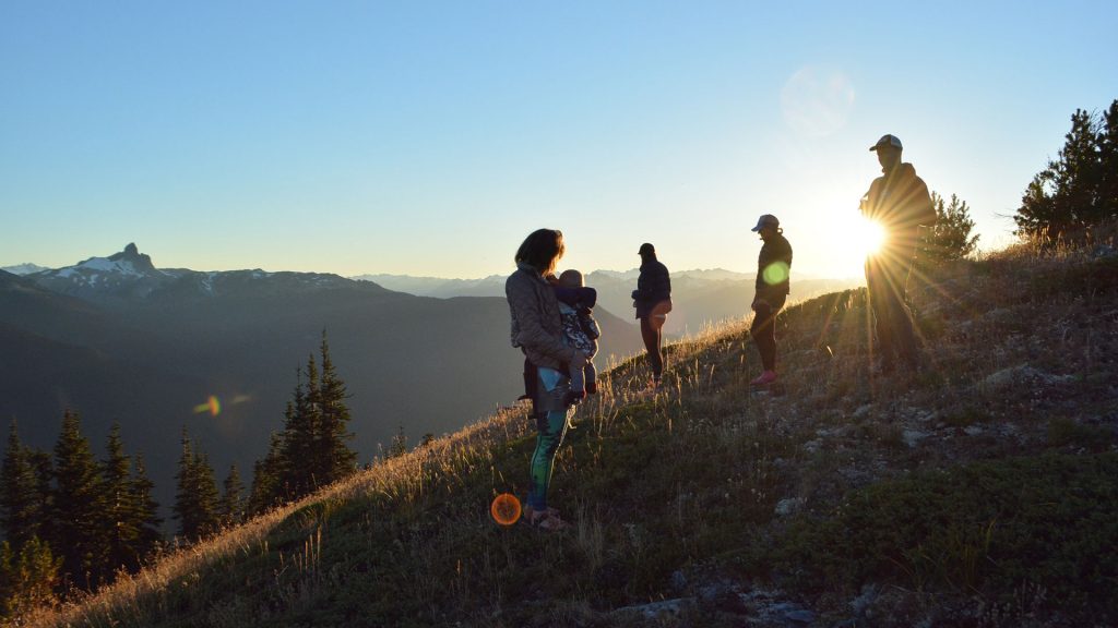 Friends and family on Whistler mountain at sunset. 