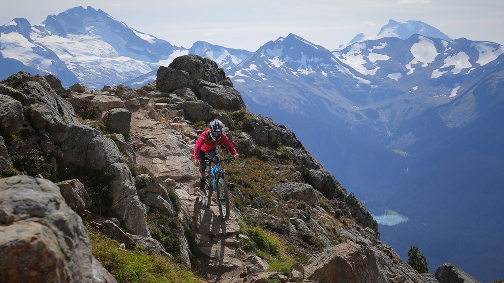 Mountain biker riding down the famous Top of the World trail in Whistler, BC