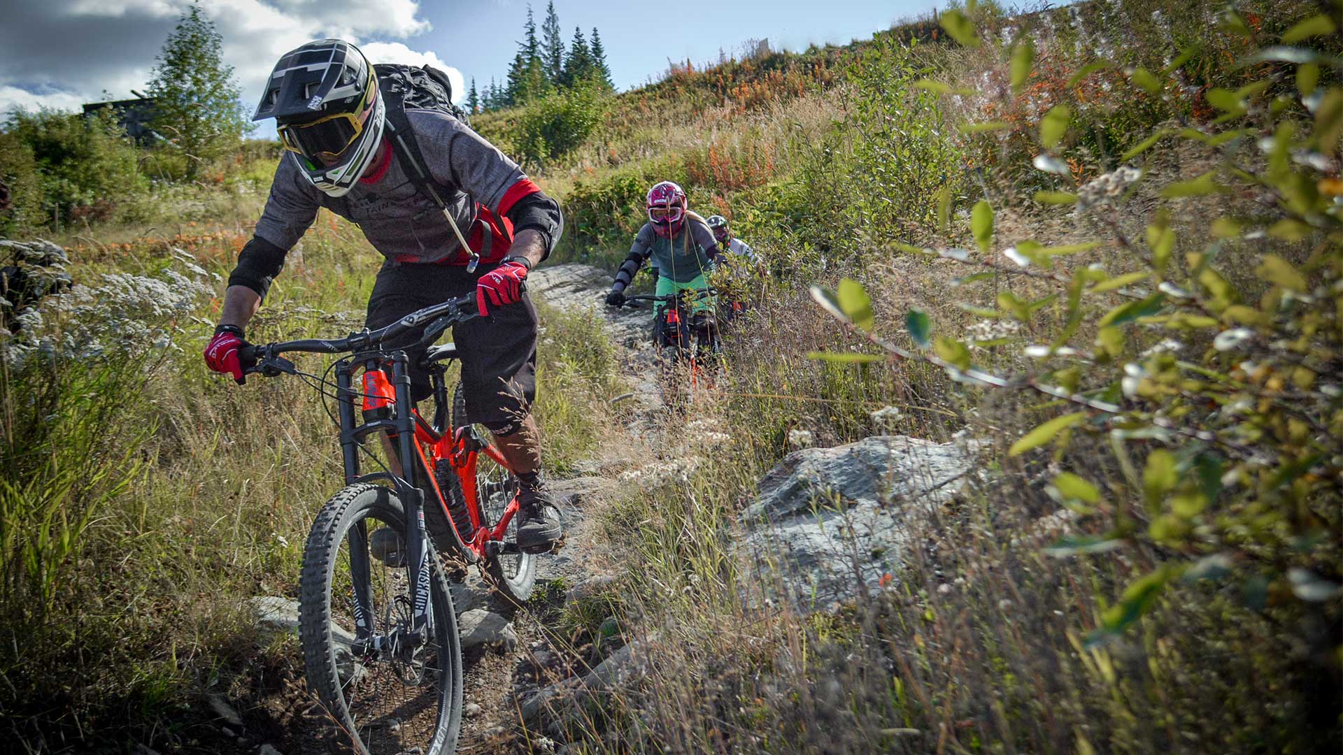 Riders biking down Whistler Mountain Bike Park