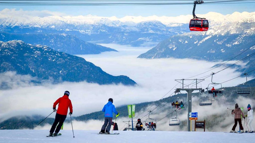 Skiers skiing through the family zone on whistler mountain. Winter activities in Whistler. 