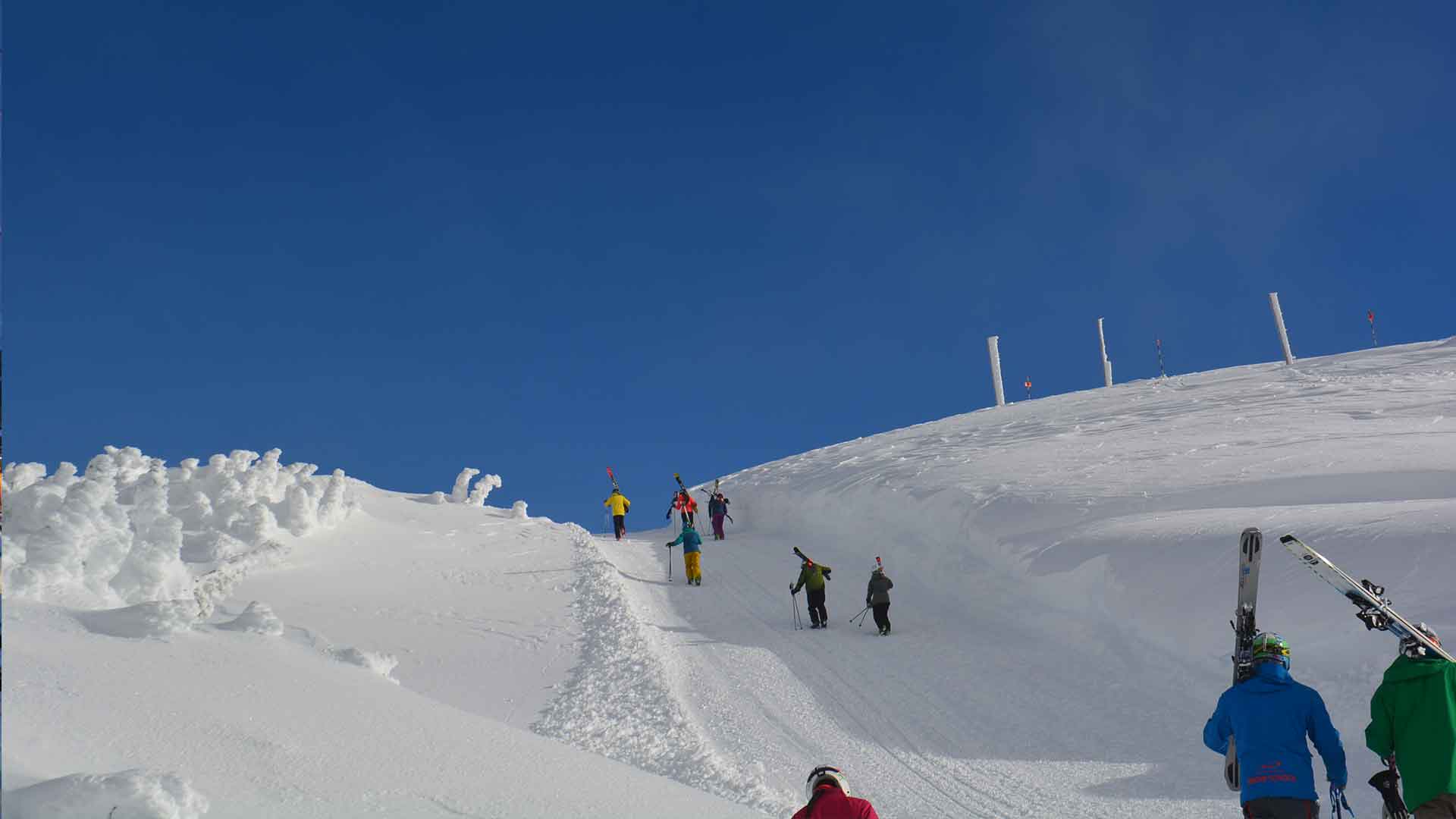 Hiking up with skis to descend Flute Bowl on Whistler Mountain