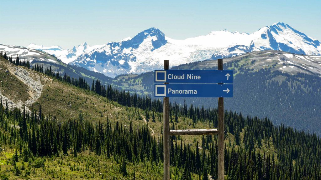 View of trail heads and snow capped mountains in Whistler. 