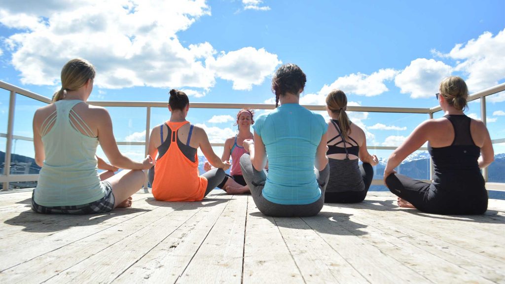Yogi's enjoying a yoga class on top of Whistler Mountain.