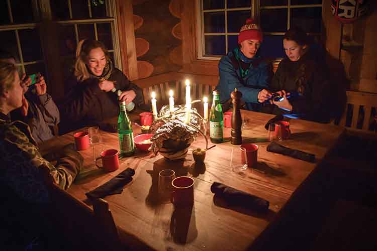 dinner in the sproatt mountain hut on a snowmobile tour