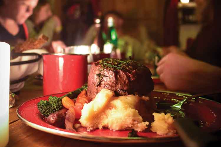 steak dinner at canadian wilderness' steak and snowmobile tour