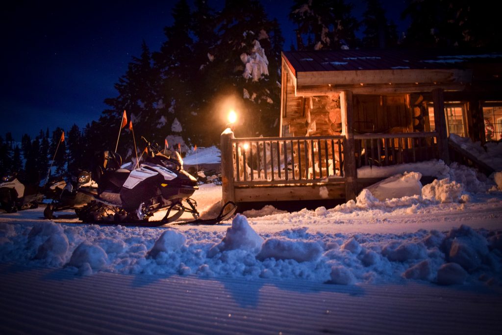 Snowmobiles parked in front of the Crystal Hut on Blackcomb Mountain in Whistler, BC. 